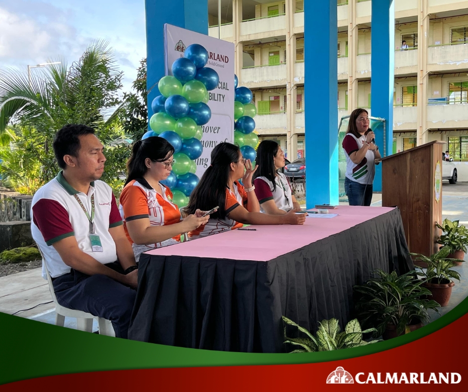 Calmar Land representatives hand over a waiting shed donation to a local school during a community ceremony, highlighting real estate support for public infrastructure.