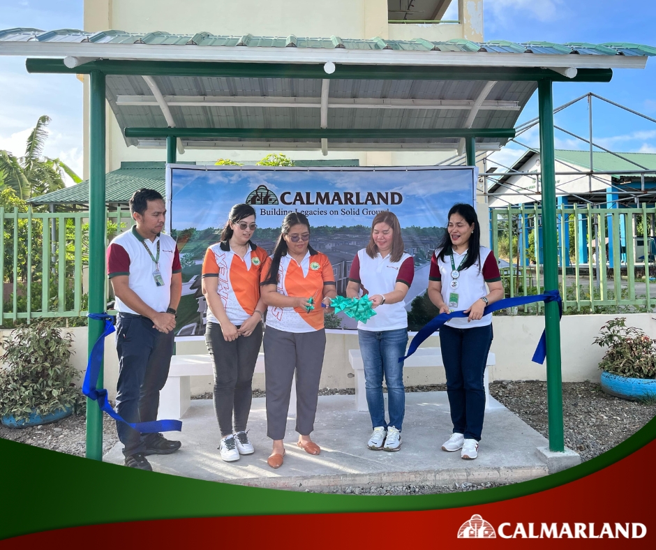 Calmar Land representatives cut the ribbon to inaugurate a newly donated waiting shed at Lucena City National High School, demonstrating the real estate company’s commitment to community development.