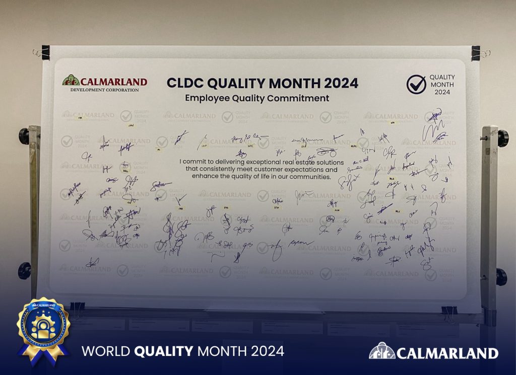 Calmarland Quality Commitment board for World Quality Month 2024, with employee signatures symbolizing dedication to excellence and quality in property development.