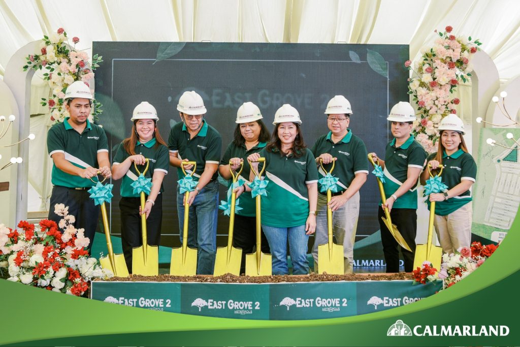 CLDC’s Board of Directors and key stakeholders leading the groundbreaking ceremony for East Grove 2, holding golden shovels adorned with blue ribbons, surrounded by festive floral decorations.